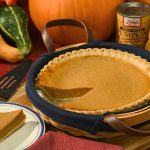 maple vanilla pumpkin pie recipe in a dish with pumpkins